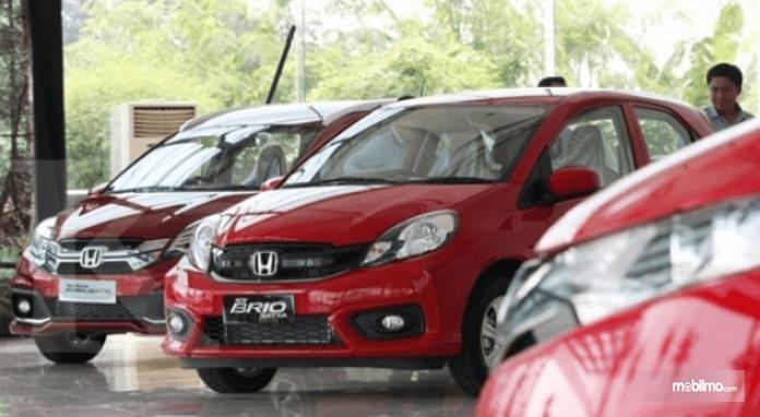 Gambar ini menunjukkan 2 mobil besutan Honda dengan warna merah